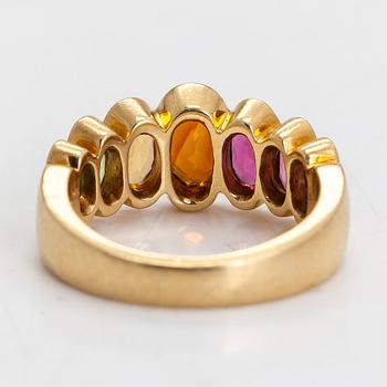 An 18K gold ring, with multi-coloured stones.