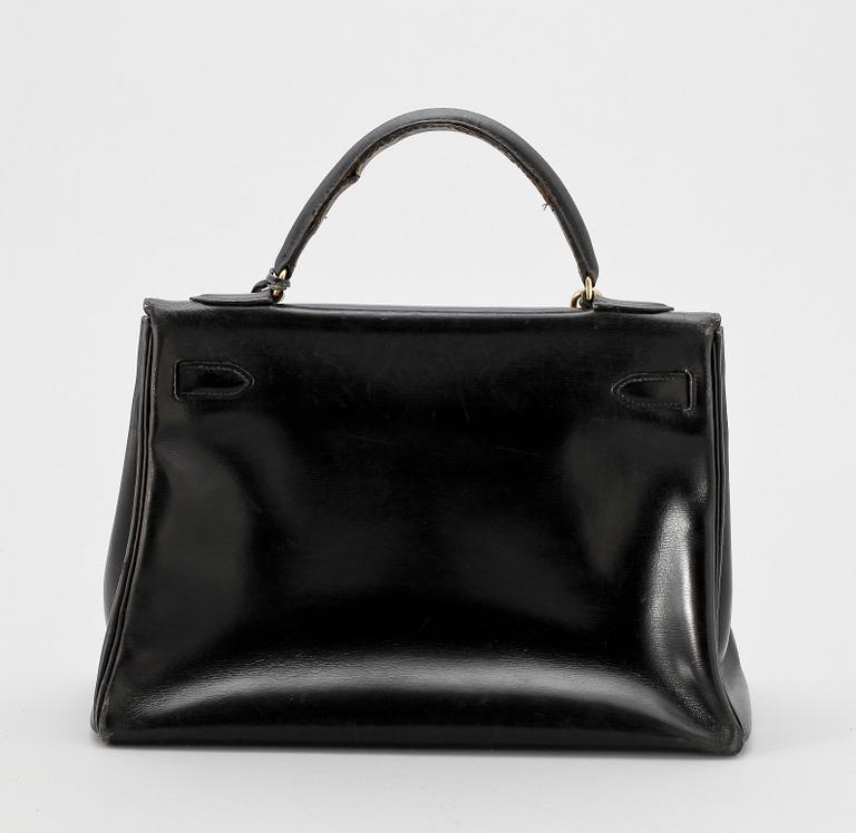 A black leather "Kelly" handbag by Hermès, prob from the 1960s.