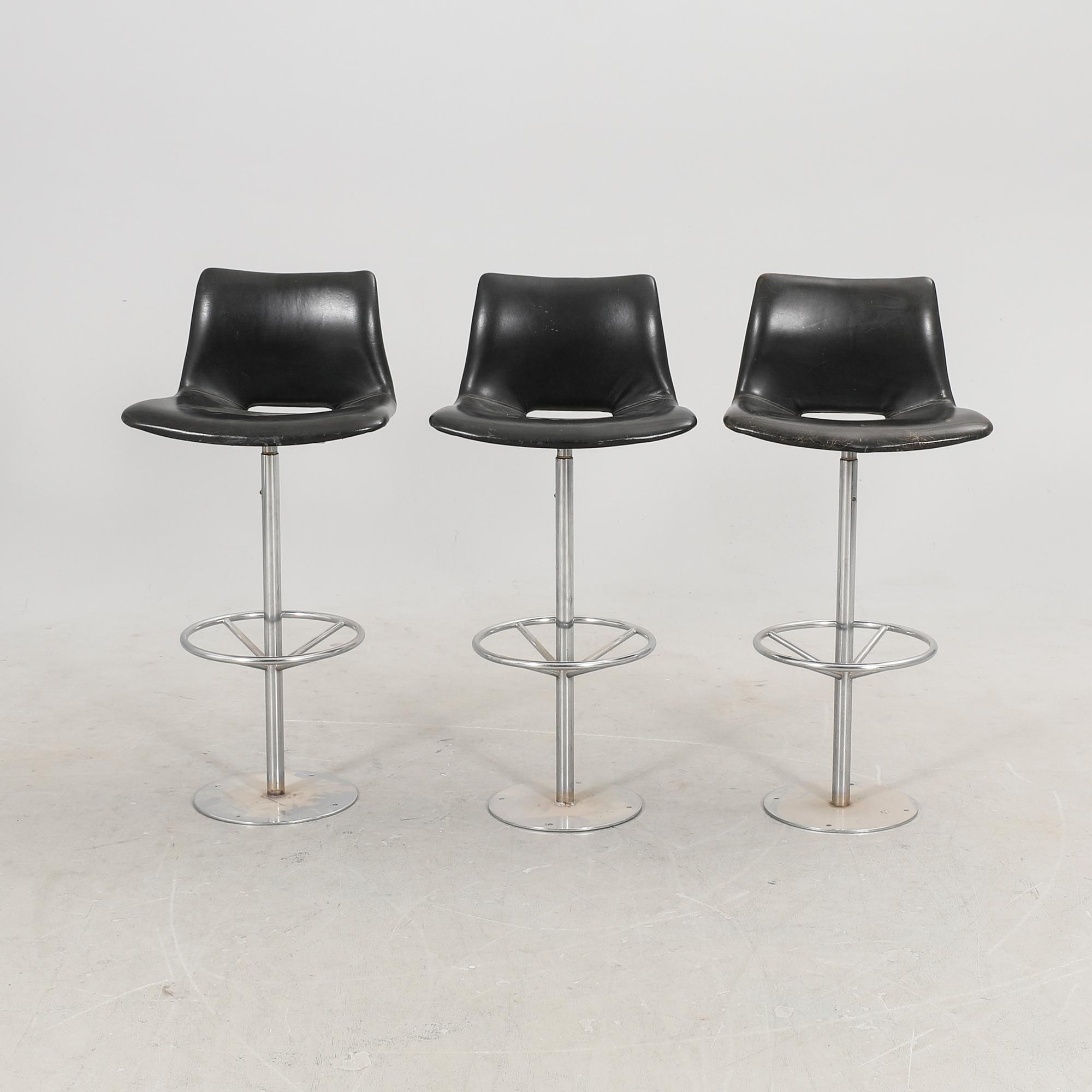 A set of three late 20th century metal and leather bar stools.