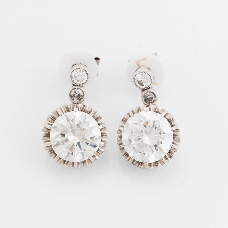 A pair of platinum earrings set with round brilliant- and old-cut diamonds.