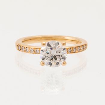 An 18K gold ring set with round brilliant-cut diamonds, GIA report.