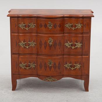 A Baroque style chest of drawers, circa 1900.