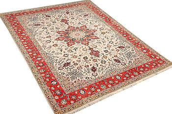 A Tabriz, part silk carpet, c. 300 x 199 cm.