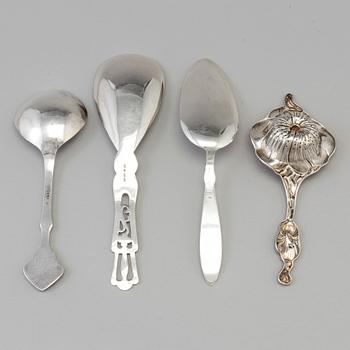 Three Art Nouveau silver serving spoons, one with maker's mark Emil O. Möller, Malmö, Sweden 1935 and a tea strainer, US.