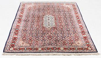 An oriental silk rug, c. 177 x 104 cm.