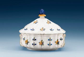 1215. A French faience tureen with cover, 18th Century.