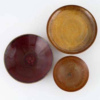 A group of three bowls, including Henning Nilsson, Höganäs.