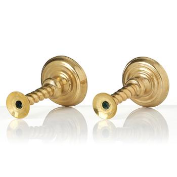 A pair of Northern European cast brass baroque candlesticks, circa 1700.