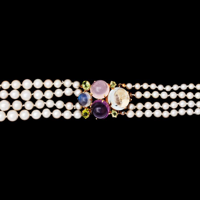 A four strand cultured pearl necklace with cabochon cut amethyst, rose quartz and aquamarine.