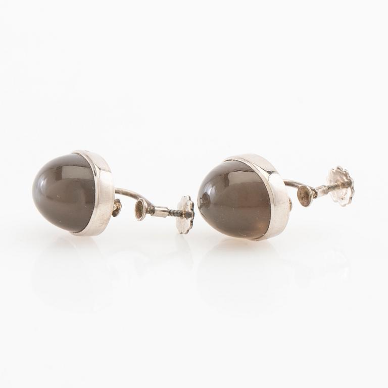 Earrings, a pair of 18K white gold with cabochon-cut grey moonstones, Gunnar Fahlström, Stockholm 1955.