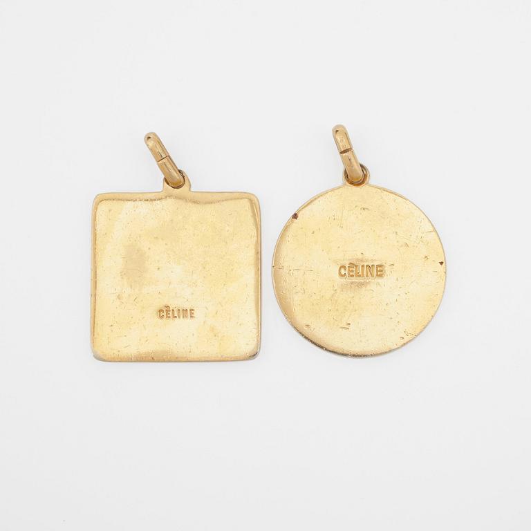 CÈLINE, two gold coloured pendants.