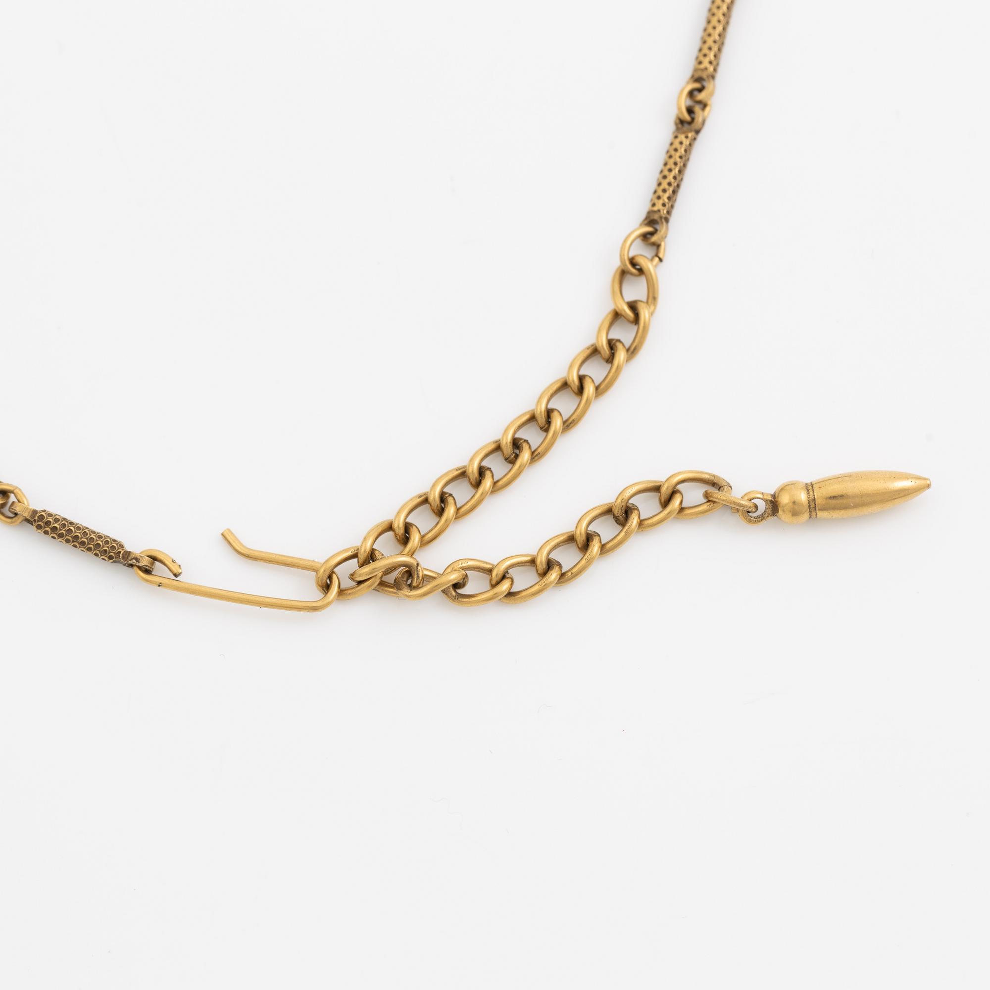 Necklace and brooch with purple stones.