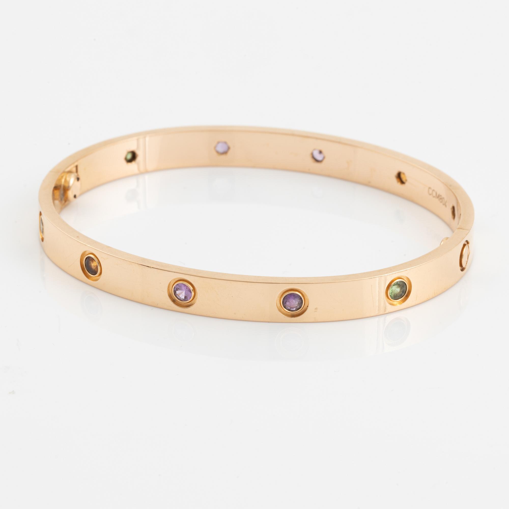 A Cartier "Love" bracelet in 18K rose gold set with colored stones.