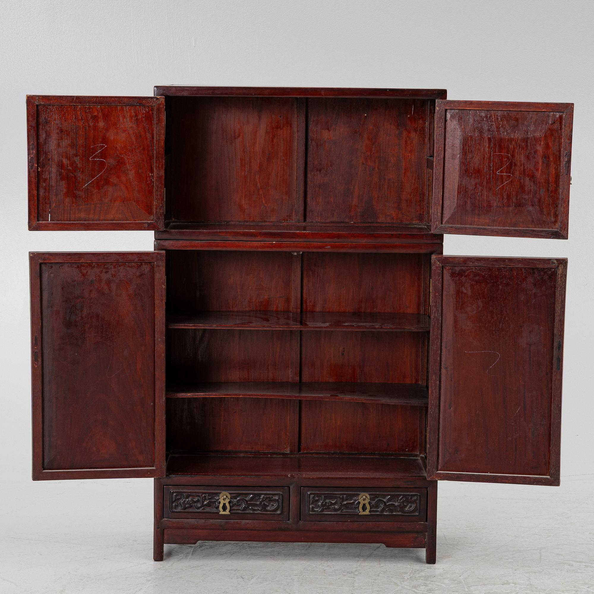 A small Chinese stained wood two part cabinet, 1900s.