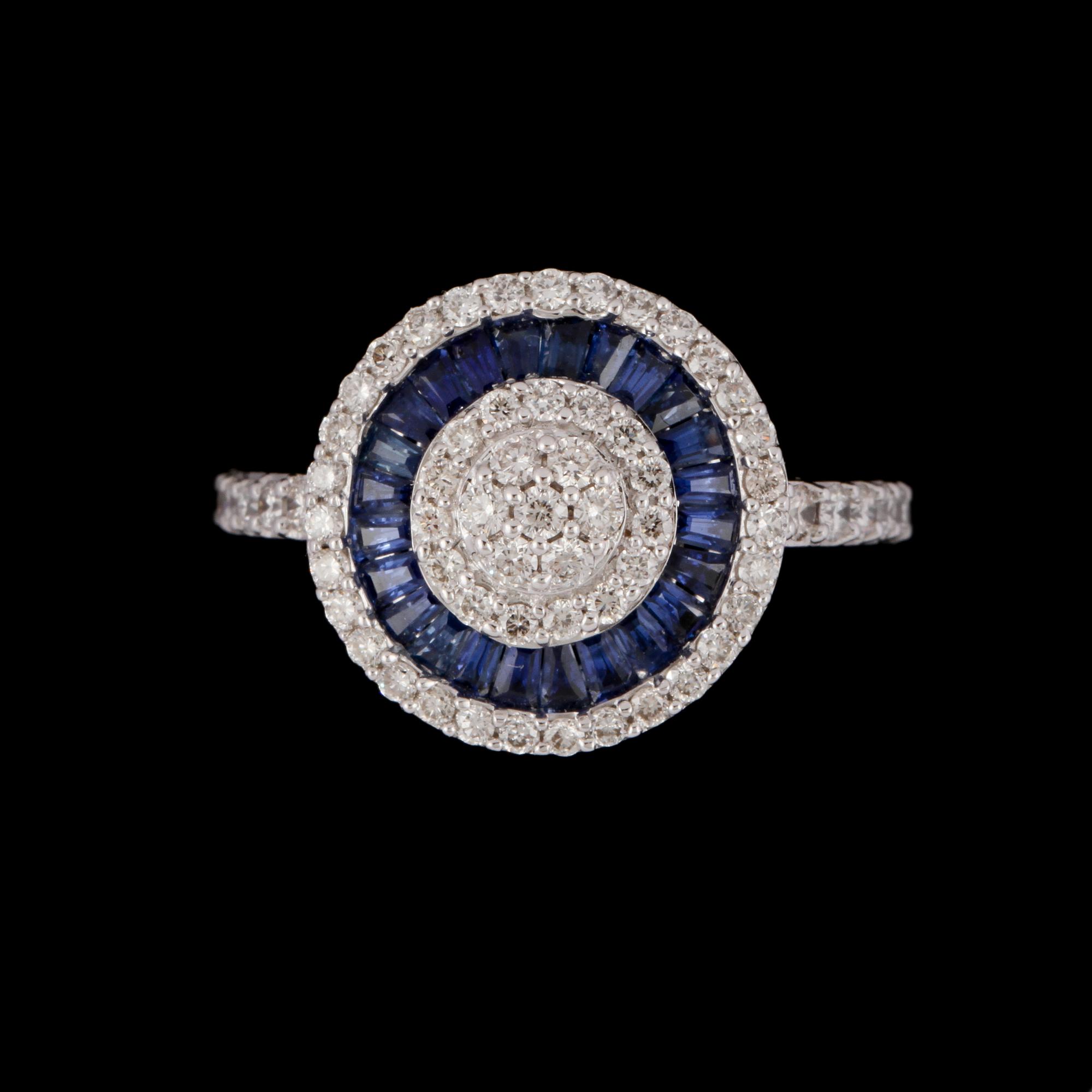 RING, 18k vitguld med 63 briljantslipade diamanter, tot  0.67 ct, samt 24 blå safirer, tot 0.72 ct. Vikt 5 g.
