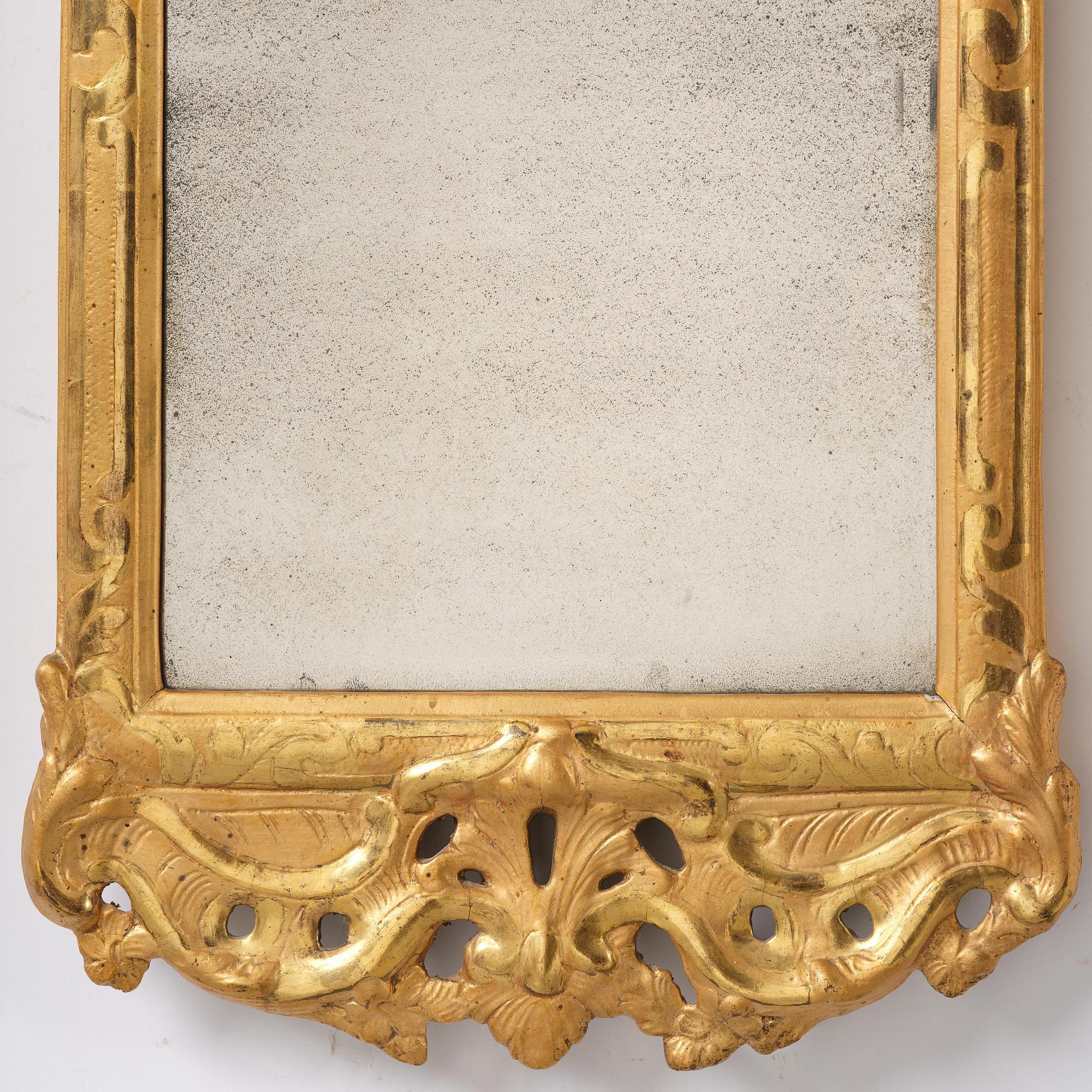 A rococo giltwood mirror by N. Meunier (master i Stockholm 1754-97).