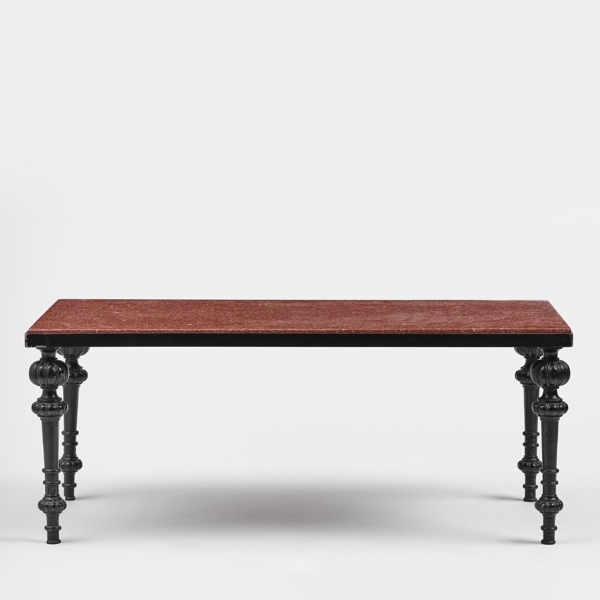 A table with granite stone top from Älvdalen, first part 19th century on a later metal stand.