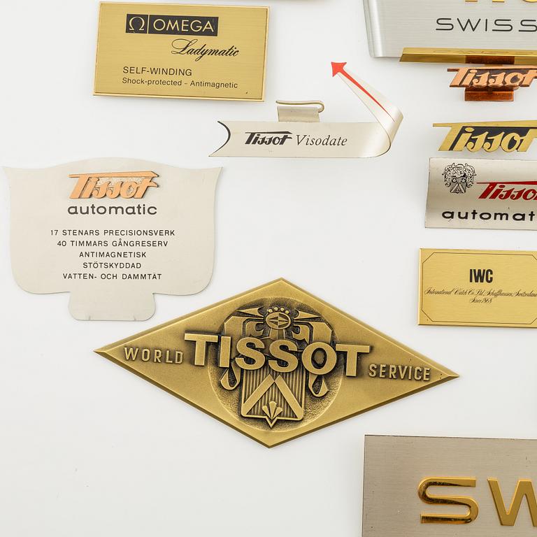 A collection of shop signs and agent plaques from Swiss watchmakers.