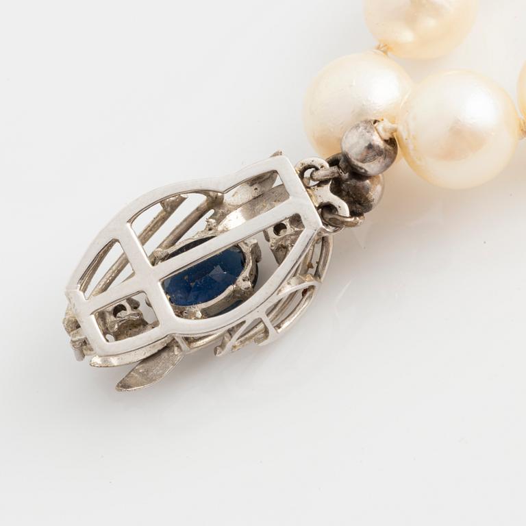 Necklace, double-stranded, cultured pearls, white gold clasp with sapphire and brilliant-cut diamonds.