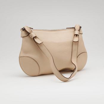 SALVATORE FERRAGAMO, a beige leather shoulder bag and a pair of beige leather loafers.