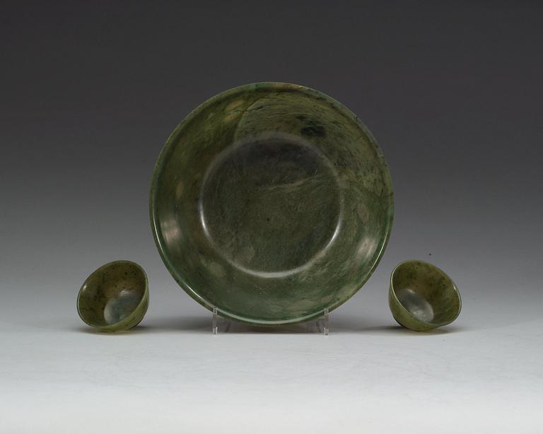 A Chinese green stone bowl and two winecups.