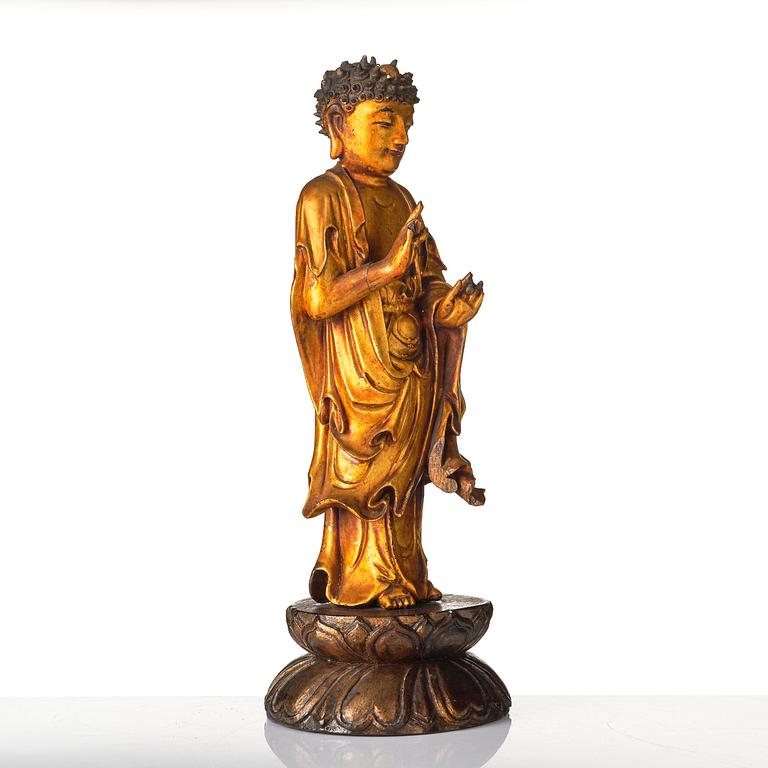 A lacquer figure of a standing Buddha, late Ming dynasty/early Qing dynasty.