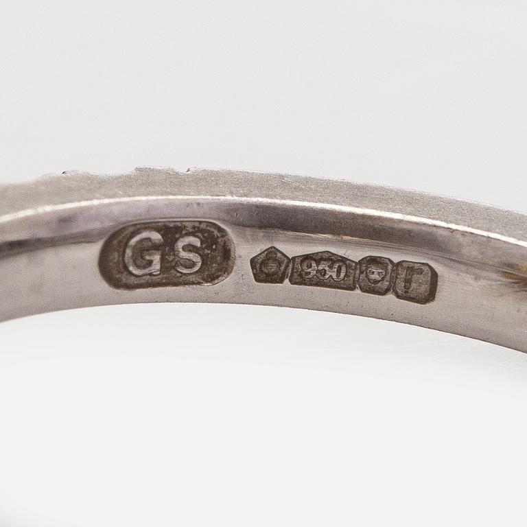 platinum ring with yellow radiant-cut diamond and brilliant cut diamonds.