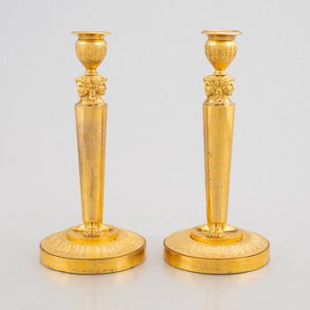 A pair of gilt-bronze Emnpire style candlesticks in the manner of Claude Galle, 19th century.