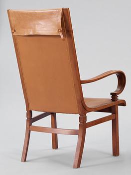 A Hjalmar Jackson pear wood and brown leather easy chair, Stockholm 1934,