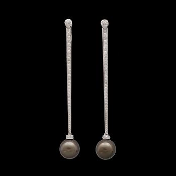 31. A cultured Tahiti pearl, 12 mm, and brilliant cut diamond, earrings, tot. 1.06 cts.