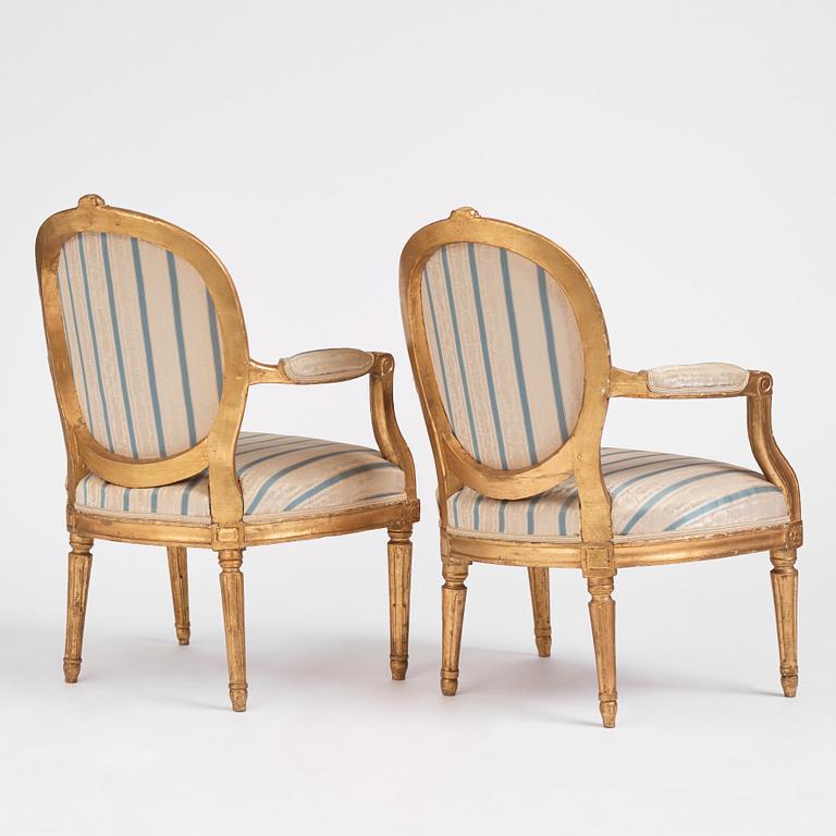 A pair of Gustavian giltwood open armchairs, late 18th century.