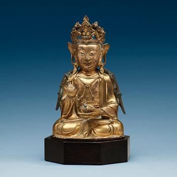 1376. A  gilt-bronze figure of a seated Guanyin, Ming dynasty (1368-1644).