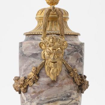 A pair of Louis XVI style urns with covers.