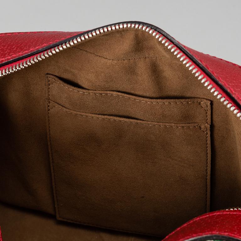 GUCCI, a patterned monogram canvas and leather bag.