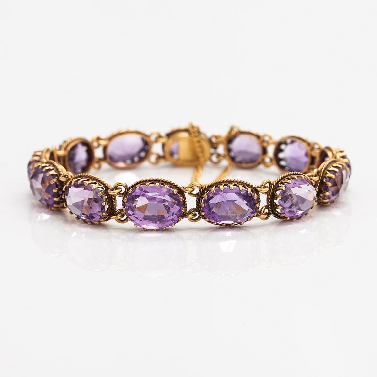 A necklace, bracelet and two brooches in gilded silver and with amethysts and pearls.
