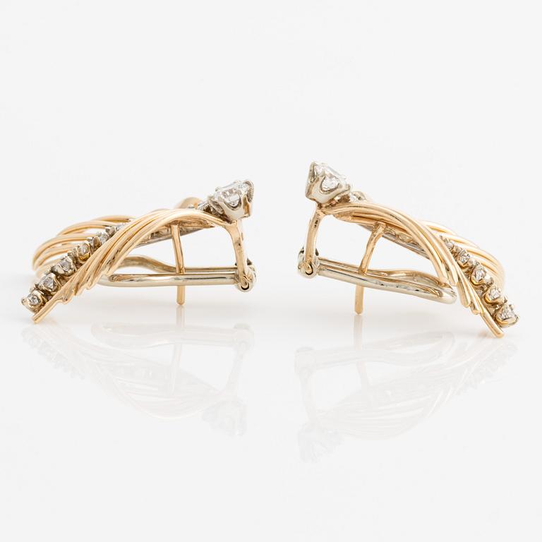 A pair of 18K gold earrings with round brilliant-cut diamonds.