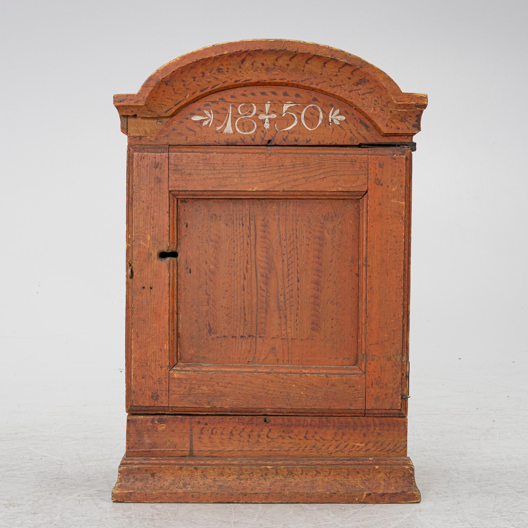 A hanging cabinet, dated 1850.