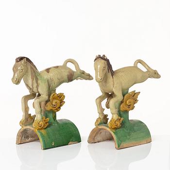 A set of two green and yellow glazed roof tiles figures of flying horses, Qing dynasty.