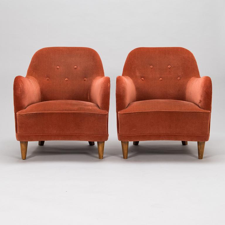 A pair of mid-20th-century armchairs.