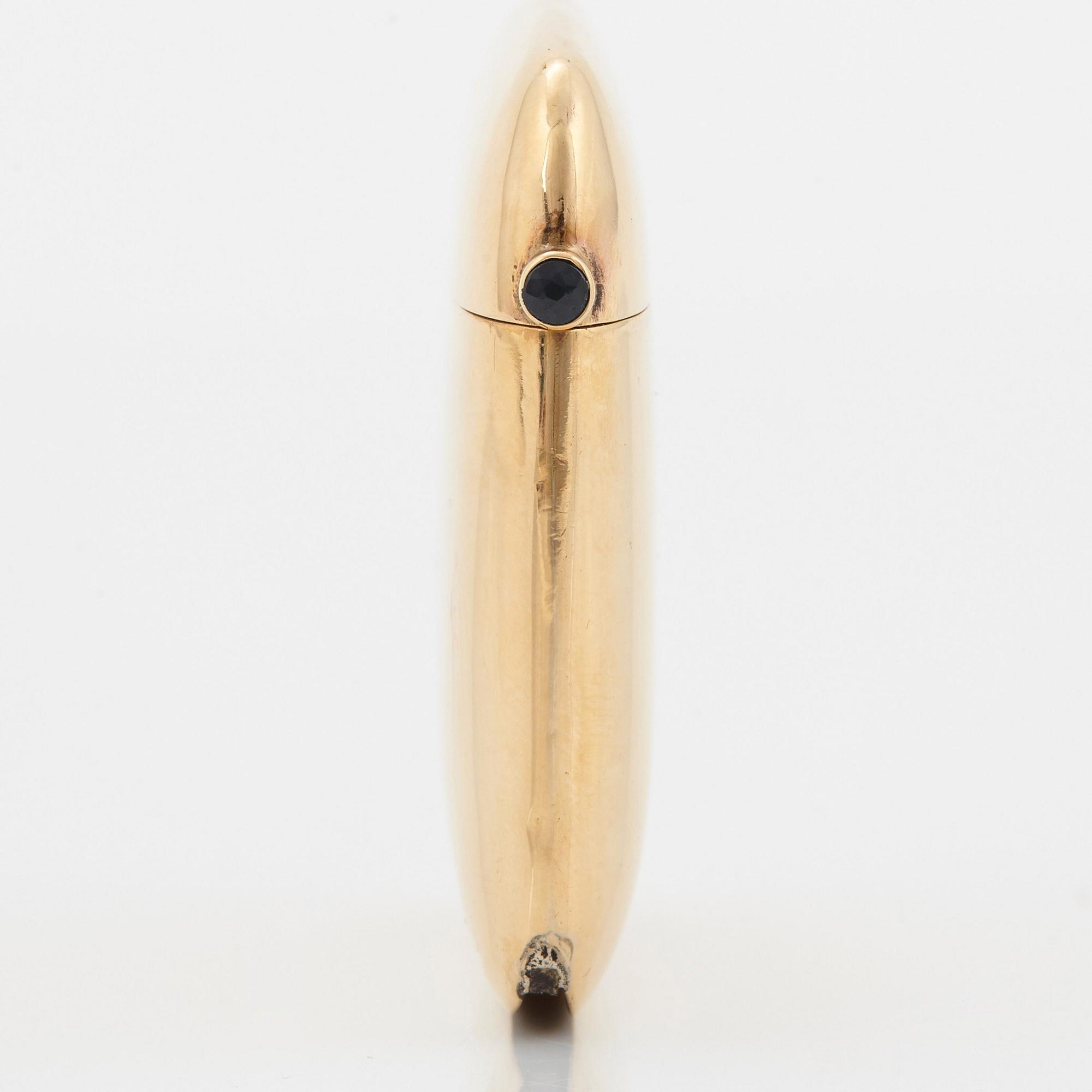 An 18K gold match case/pendant set with a faceted sapphire.