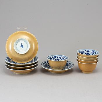 Five blue and white and cafe au lait glazed cups with dishes, Qing dynasty, Qianlong (1736-95).
