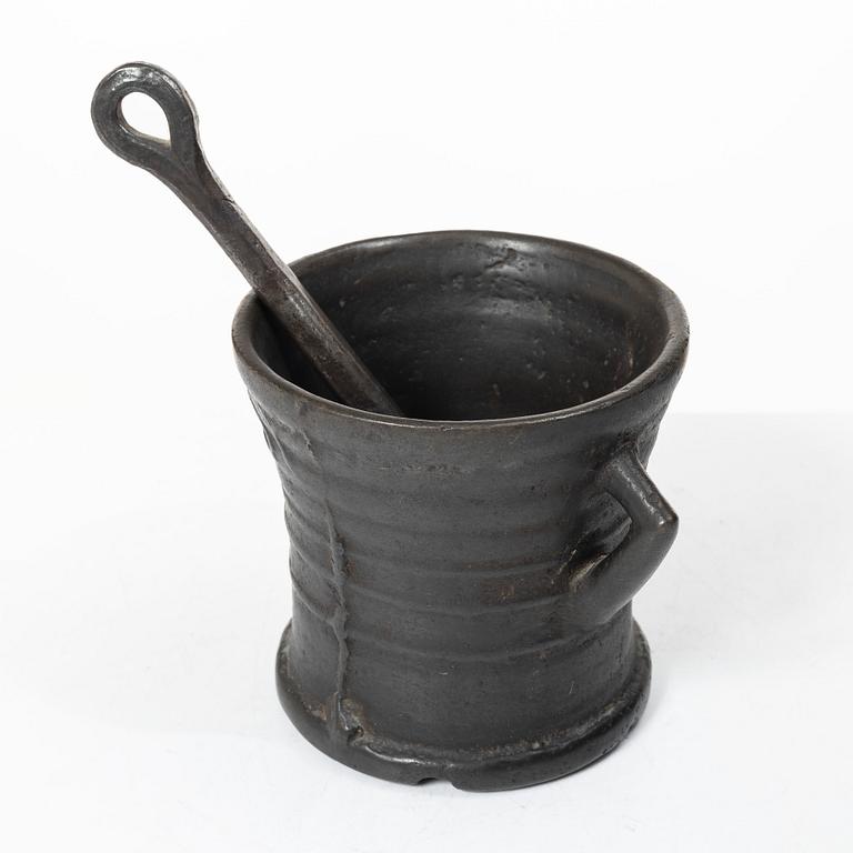 Mortar and pestle, dated 1673.