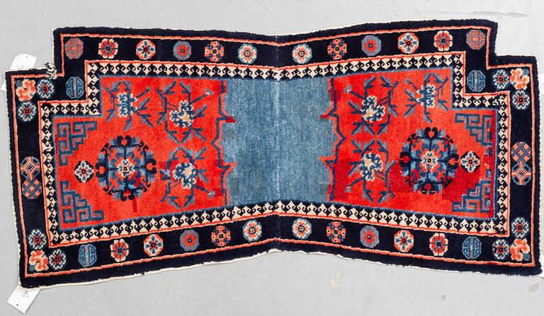 Matto, a saddle cover/a rug, semi-antique/old China, ca 129 x 63 cm.
