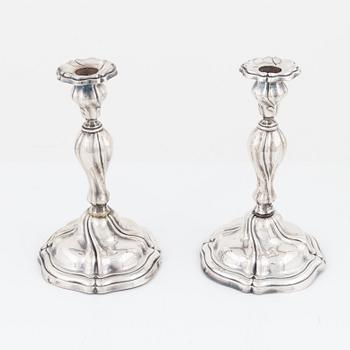 A pair of Rococo style silver candlesticks, bearing Swedish import marks, first half of the 20th Century.