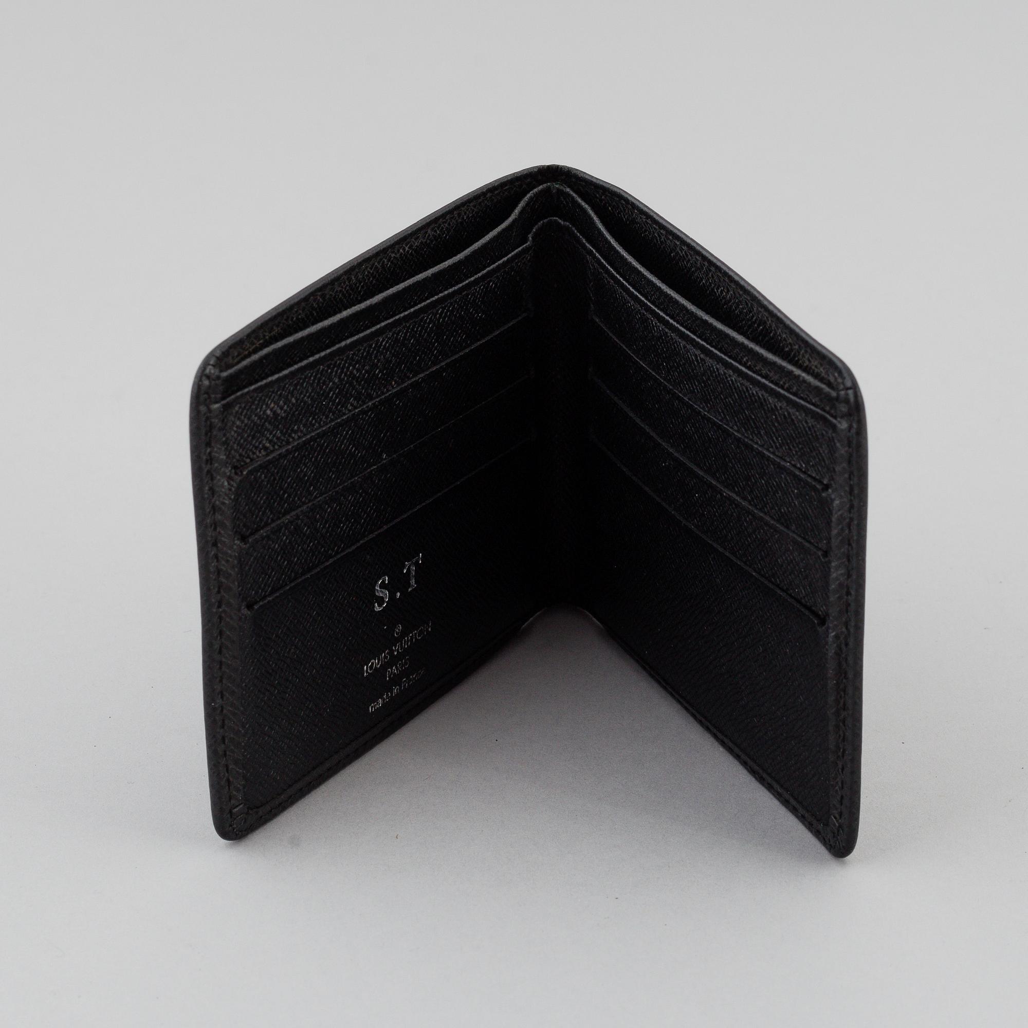LOUIS VUITTON, black taiga leather wallet.