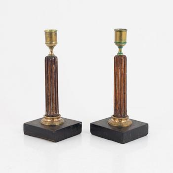 A pair of late Gustavian gilt brass, mahogany, and bog oak candlesticks, circa 1800.