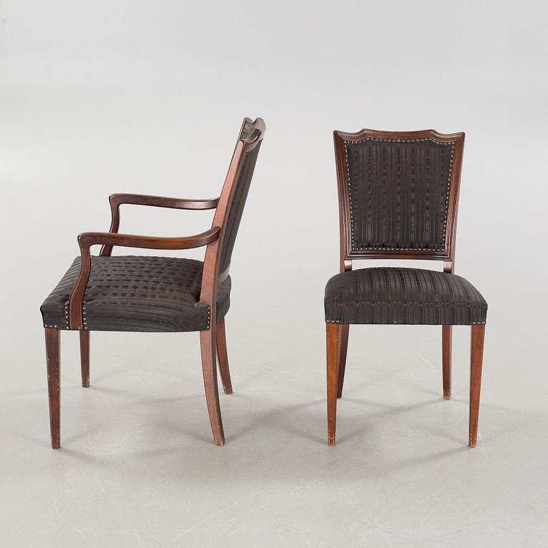 An english style dining table and eight chairs, second half of the 20th century.