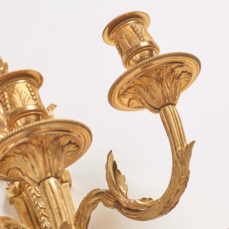 A pair of Louis XVI late 18th century gilt bronze three-light wall-lights.