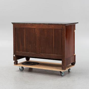 A French Empire mahogany and gilt brass mounted commode, early 19th century.