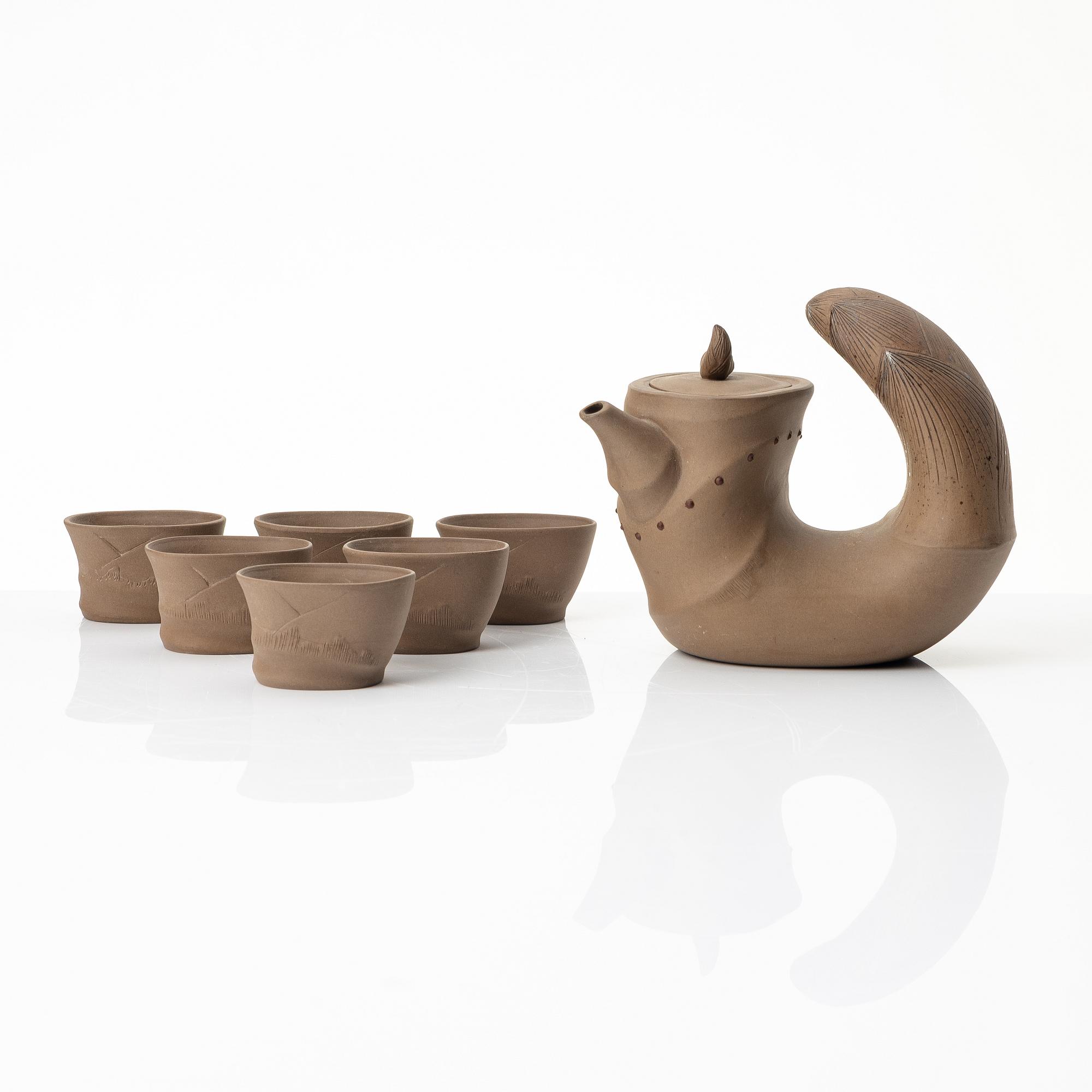 A grey yixing 'bamboo shoot' teapot with six cups, China, 1980s.